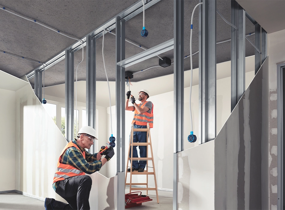 Two men in orange safety vests working inside the SPOT construction project in Amsterdam (photo)