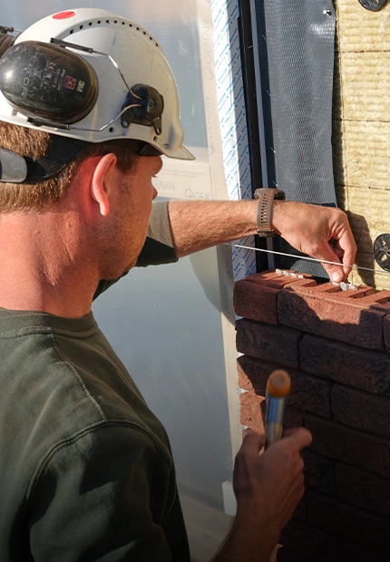 A worker lays bricks during the renovation and extension of the historic Orangery in Baarn, the Netherlands, using the wienerberger ClickBrick system (photo)